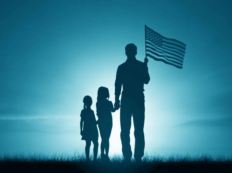 Family holding hands under the American flag.