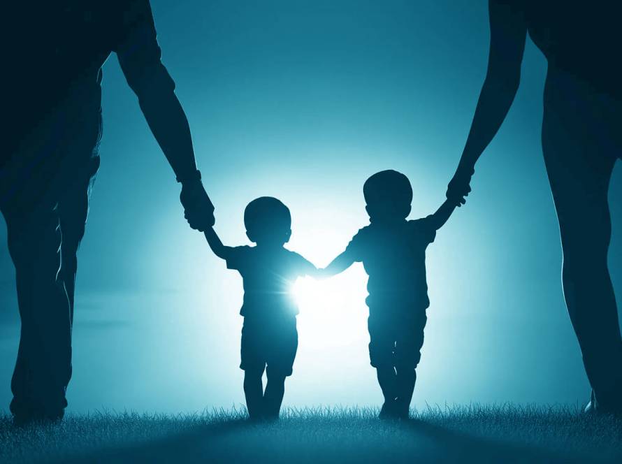 Two children holding hands under sunlight, symbolizing child immigration petitions.
