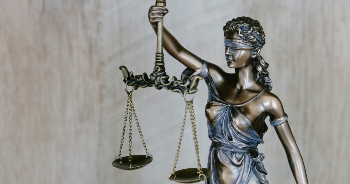 Bronze statue of Lady Justice holding the scales of justice — symbol of fair adjudication in U.S. immigration cases involving criminal convictions